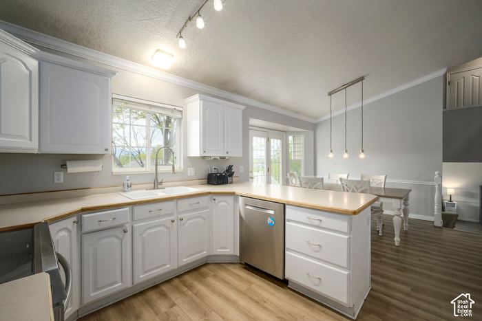 Kitchen with white cabinets, bar seating, and a window over the sink